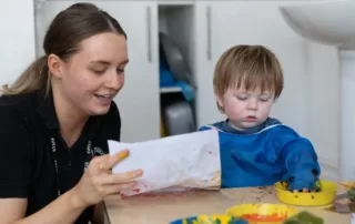 Staff providing learning experiences for nursery children