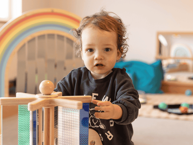child-playing-with-wooden-toy